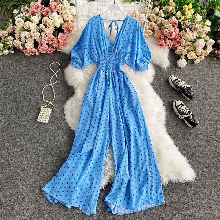 Tuta estiva donna a pois, vita smock e gamba larga. Perfetta per look casual chic primavera/estate.