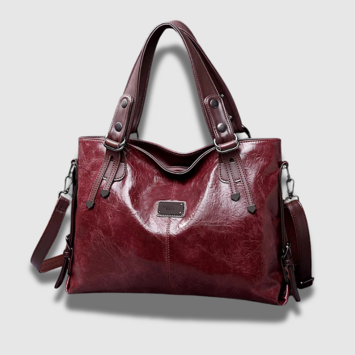Elegante borsa donna in pelle lucida di alta qualità. Borsa a mano e tracolla regolabile per ogni occasione.