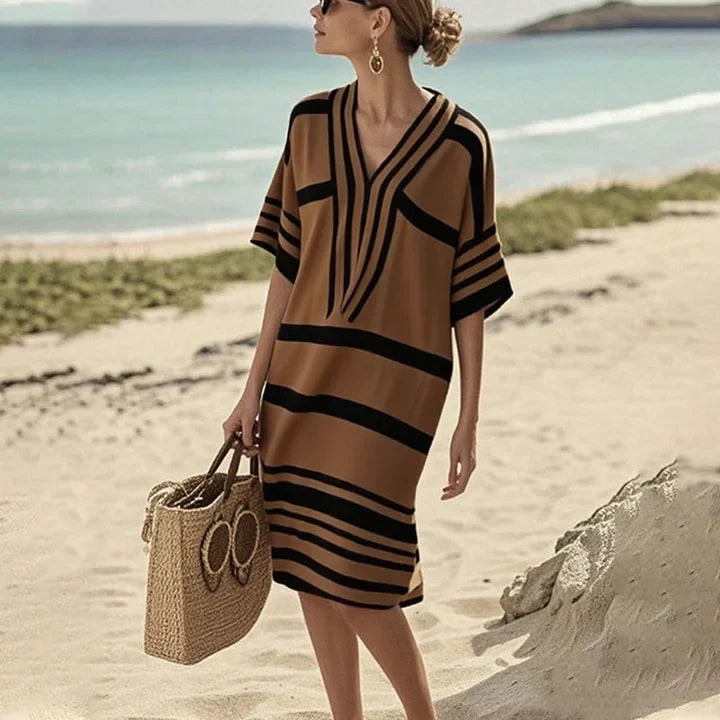 Vestito midi a strisce fluide per donna, scollo a V. Eleganza casual estiva, ideale per il giorno.