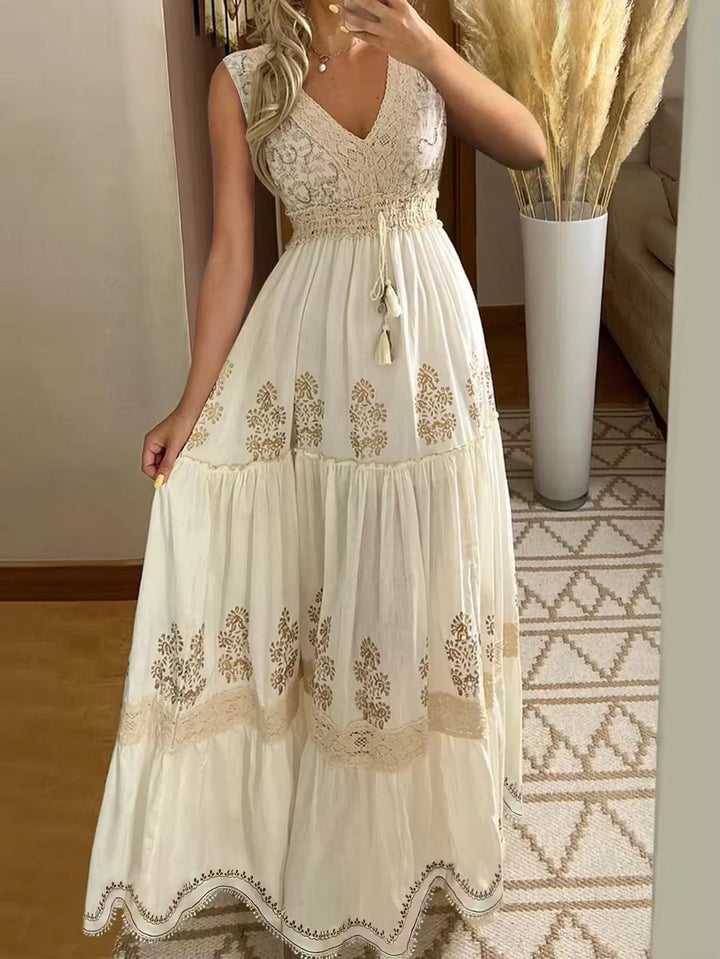 Abito lungo estivo donna elegante con scollo a V, ricami floreali e vita elasticizzata, perfetto per vacanze o spiaggia.