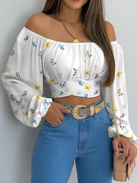 Blouse corta donna off-shoulder, maniche lunghe. Elegante e casual chic, must-have per la moda primavera estate.