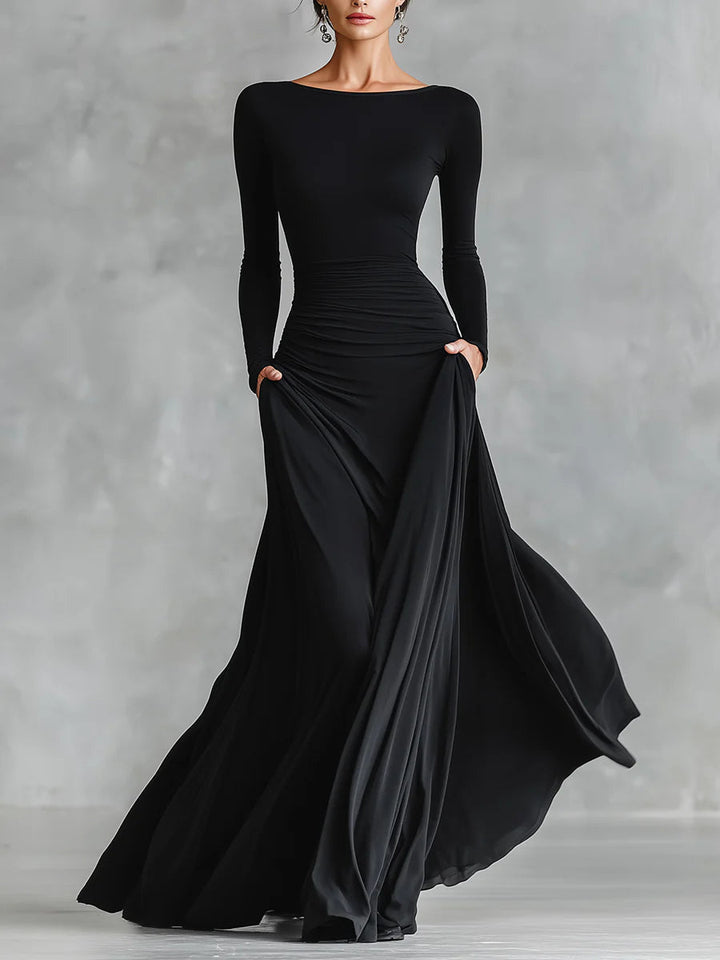 Abito lungo donna nero elegante, scollo a barca e maniche lunghe, perfetto per serate e occasioni formali.