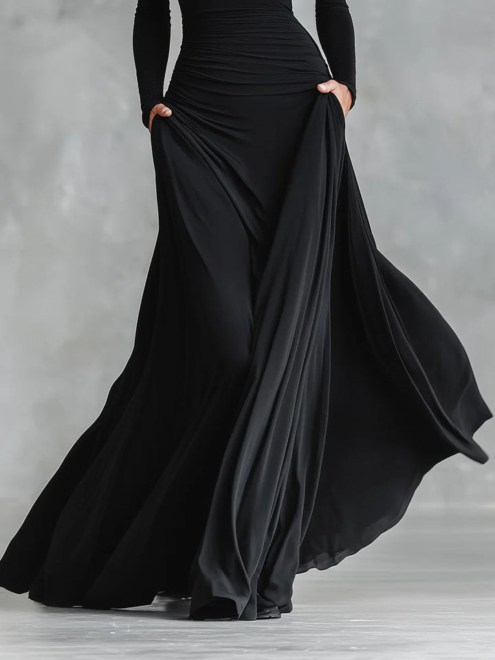 Vestito formale nero donna, abito lungo con scollo a barca e maniche lunghe, per un look sofisticato e moderno.