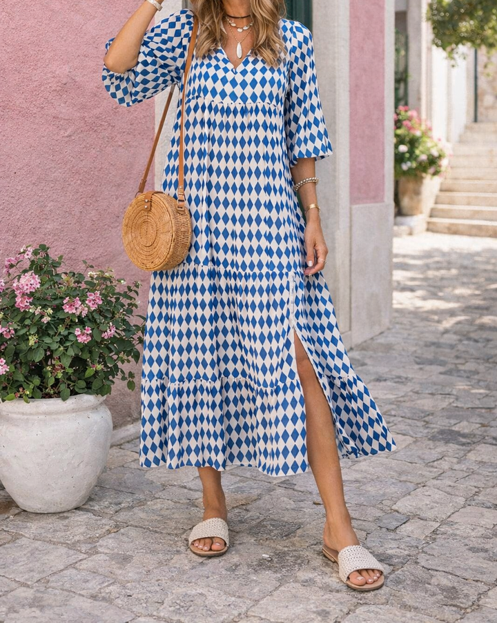 Abito lungo donna scollo a V con delicate maniche a volant e stampa geometrica. Stile fluido ed elegante.