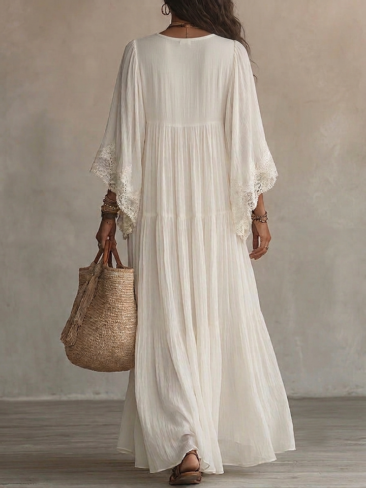 Maxi dress estivo bohemien da donna bianco con pizzo, scollo a V, perfetto per vacanze e moda mare.