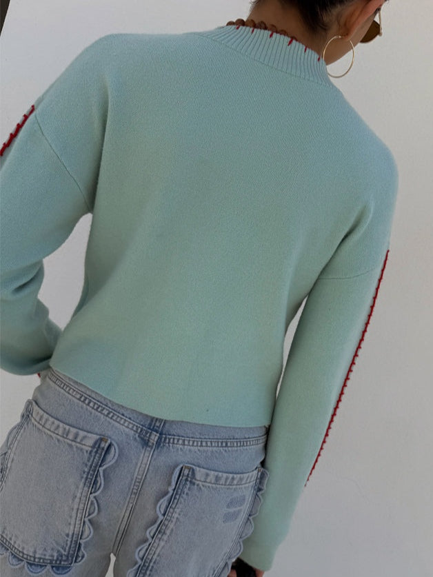Morbido cardigan donna azzurro, vestibilità rilassata, con vivace polpo. Perfetto per abbigliamento casual quotidiano.