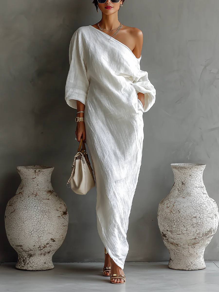 Abito maxi monospalla nero, elegante e fluido, perfetto per serate o cerimonie estive.