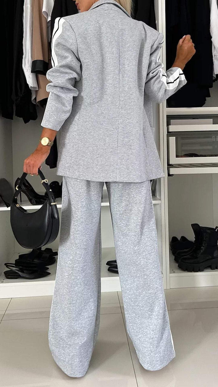 Outfit donna estivo rilassato: completo giacca a righe e pantaloni larghi, perfetto per la moda casual.