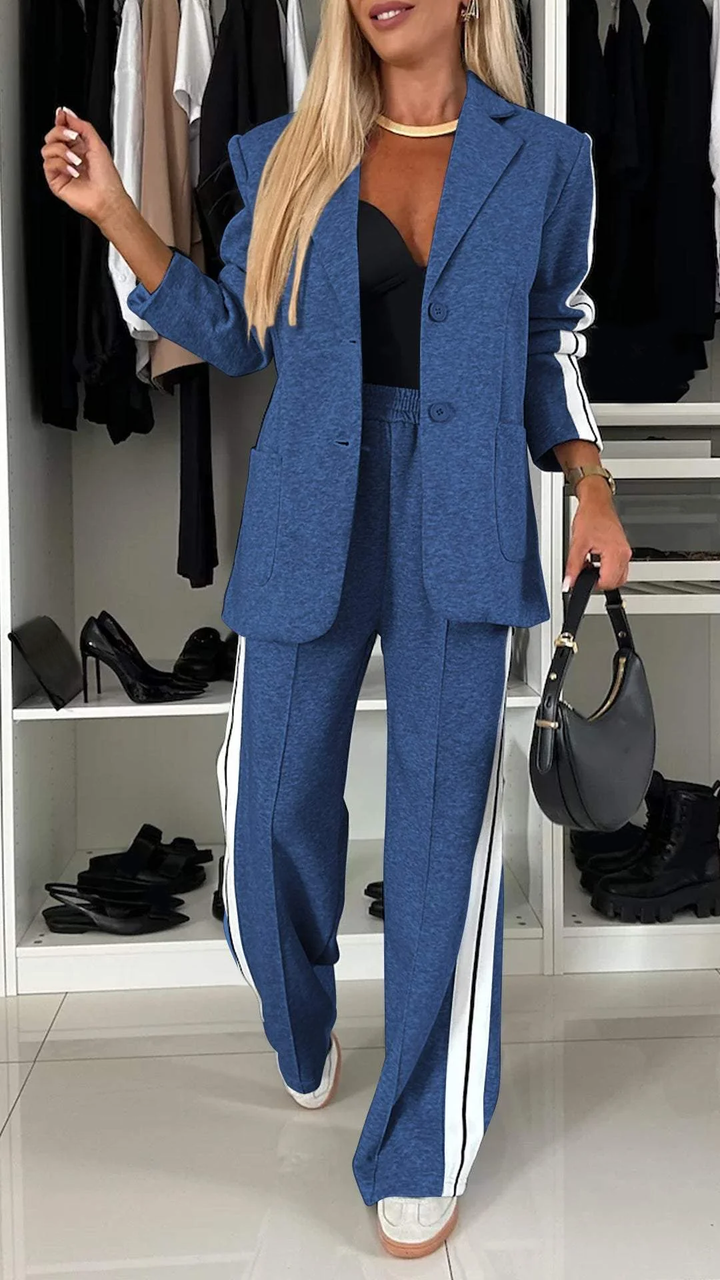 Completo giacca e pantaloni ampi a righe larghe per donna. Outfit casual chic perfetto per la primavera.