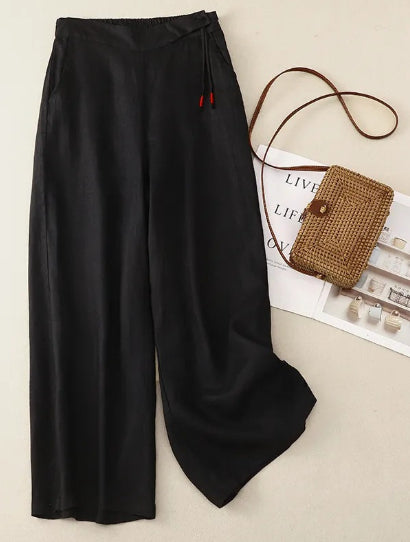 Eleganti pantaloni donna ampi in lino a vita alta, gamba larga e tasche. Comfort e stile casual-chic.