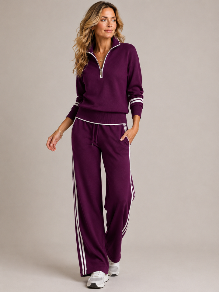 Completo donna bianco con felpa zip e pantaloni sportivi, ideale per viaggi o uno stile rilassato.