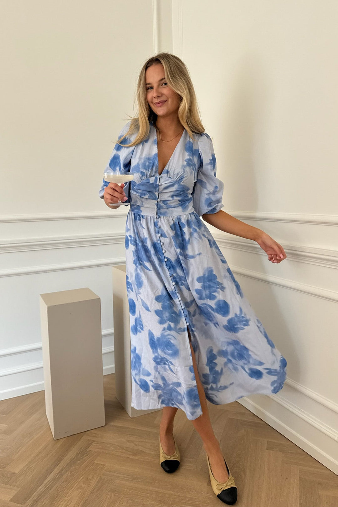 Abito donna midi blu con stampa floreale, maniche lunghe e bottoni decorativi. Stile elegante e confortevole.