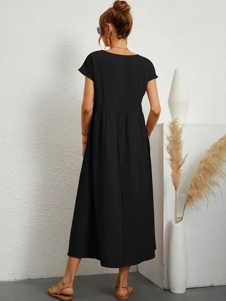 Abito midi donna con maniche kimono e vita alta, ideale per l'autunno casual ed elegante.