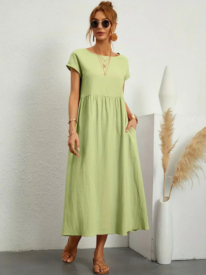 Vestito donna midi autunnale, maniche kimono, tasche, per un look pratico e chic senza sforzo.