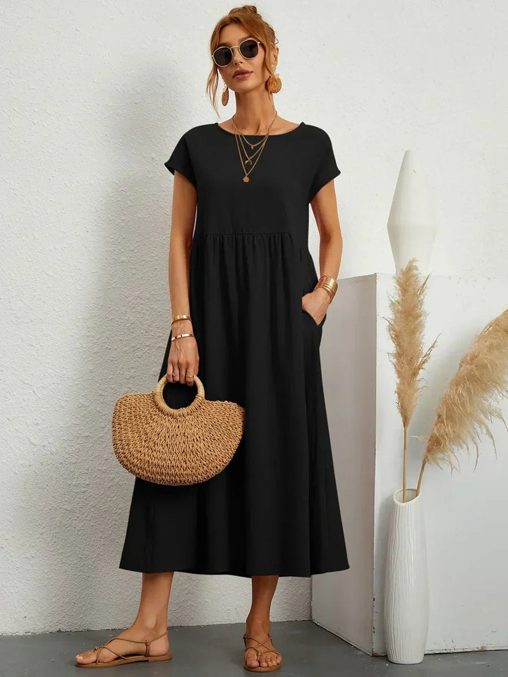 Vestito midi donna con scollo rotondo e maniche kimono, perfetto per un look autunnale chic.