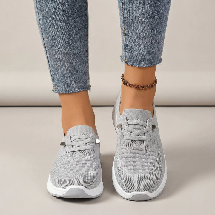 Sneakers ortopediche da donna grigie con suola ammortizzata per comfort duraturo e supporto plantare.