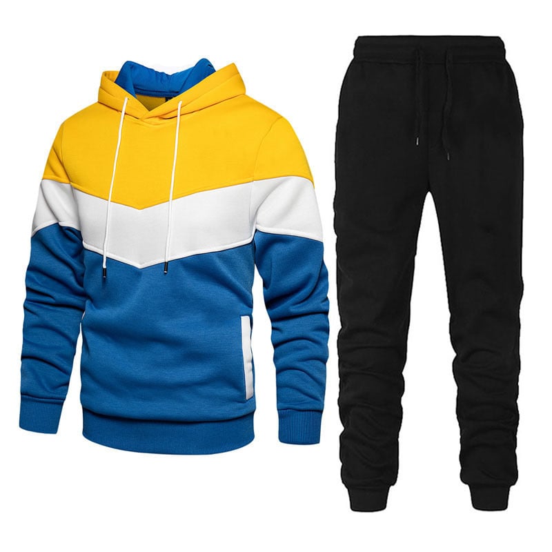 Tuta uomo sportiva e casual con felpa patchwork e pantaloni. Set due pezzi confortevole, ideale per il tempo libero e moda.
