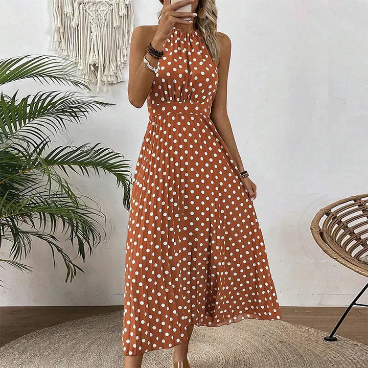 Abito maxi elegante da donna con scollo halter e stampa a pois, perfetto per l'estate.