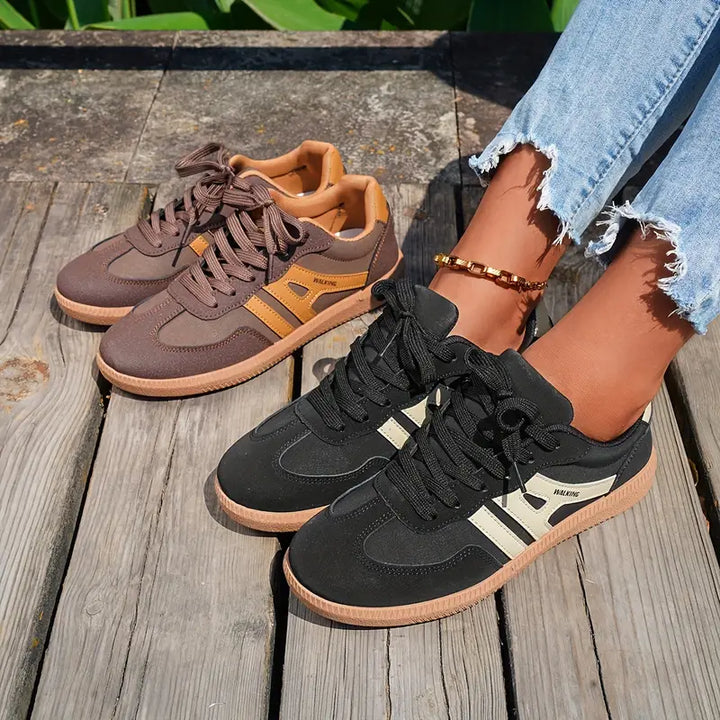 Sneakers donna Retro Chic in nero e caffè. Comfort quotidiano con design inconfondibile e suola leggera per ogni passo.