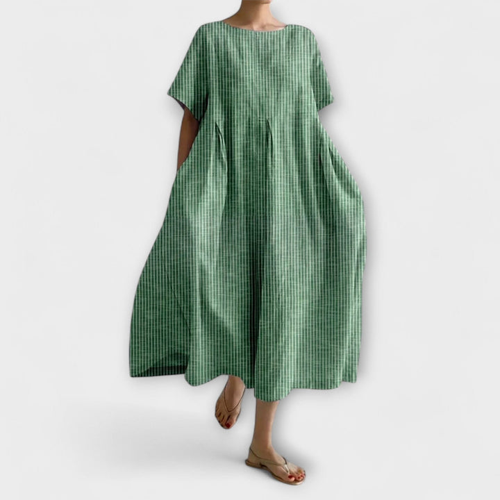 Vestito donna midi oversize a righe, con ampie maniche kimono e tasche, perfetto per un comfort casual ed estivo.