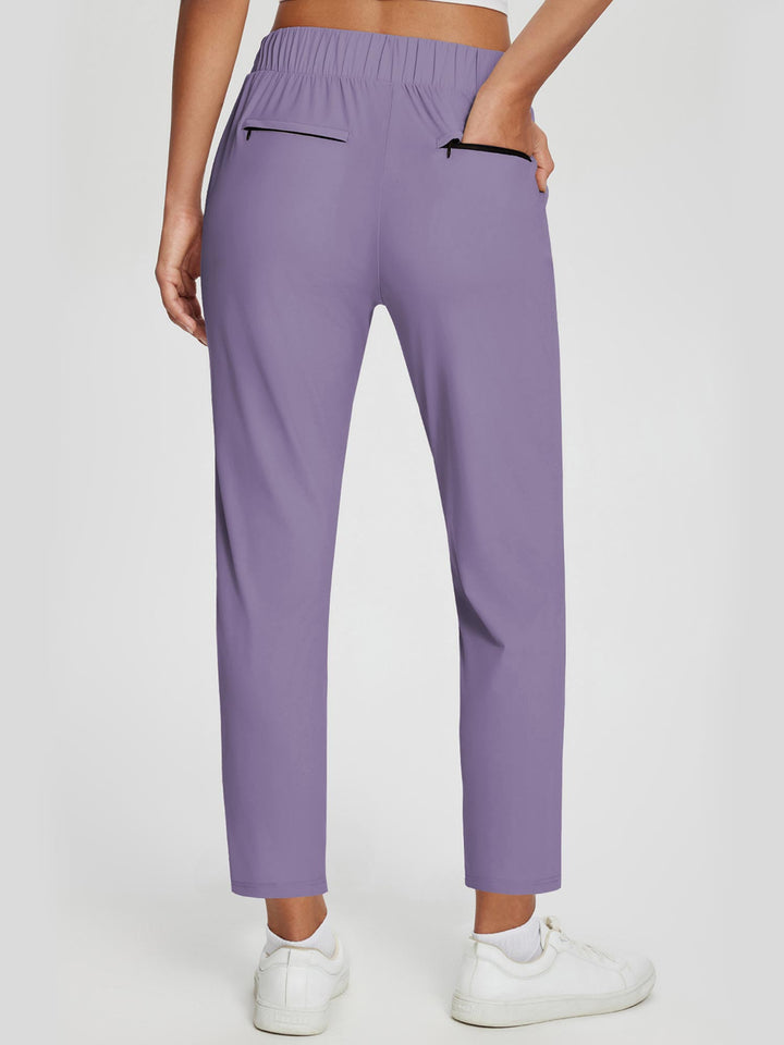 Pantaloni donna casual/sportivi, vita alta, UPF 50+, spacco e tasche. Per comfort quotidiano.