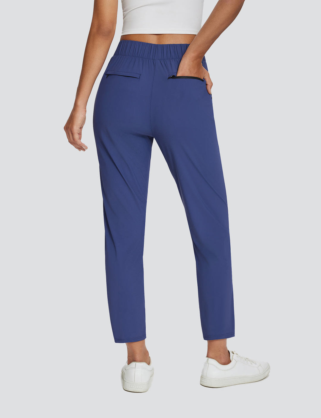 Pantaloni sportivi donna con vita alta, tasche multiple, UPF 50+, ideali per hiking e viaggio.
