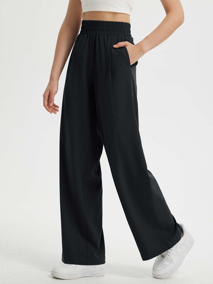 Pantaloni eleganti da donna a gamba larga, vita elastica e tasche. Comfort e stile in un unico capo.