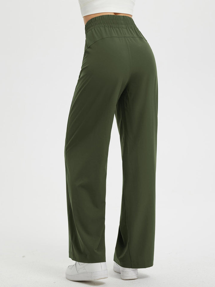 Pantaloni donna versatili con gamba larga, vita elastica e tasche. Adatti per look casual o più formali.