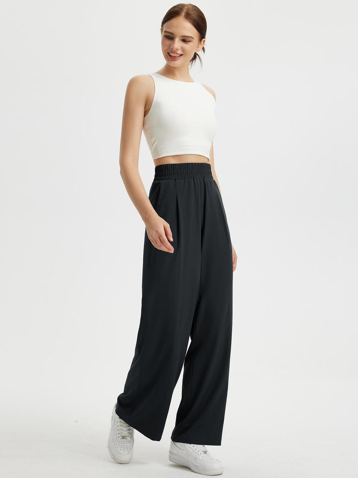 Pantaloni donna a gamba larga, vita elastica e tasche. Tessuto confortevole con protezione UV estiva.