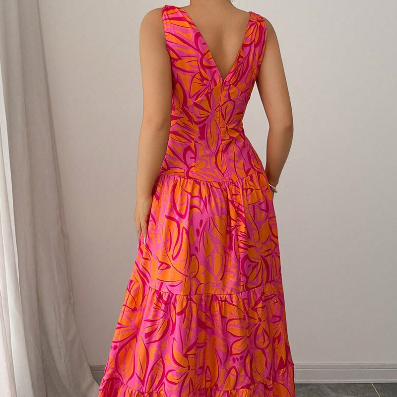 Abito donna lungo con vibrante stampa tropicale rosa e arancio. Vestito estivo perfetto per un look vacanziero chic.