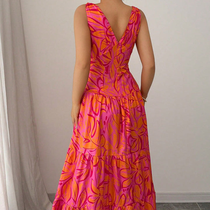 Abito donna lungo con vibrante stampa tropicale rosa e arancio. Vestito estivo perfetto per un look vacanziero chic.