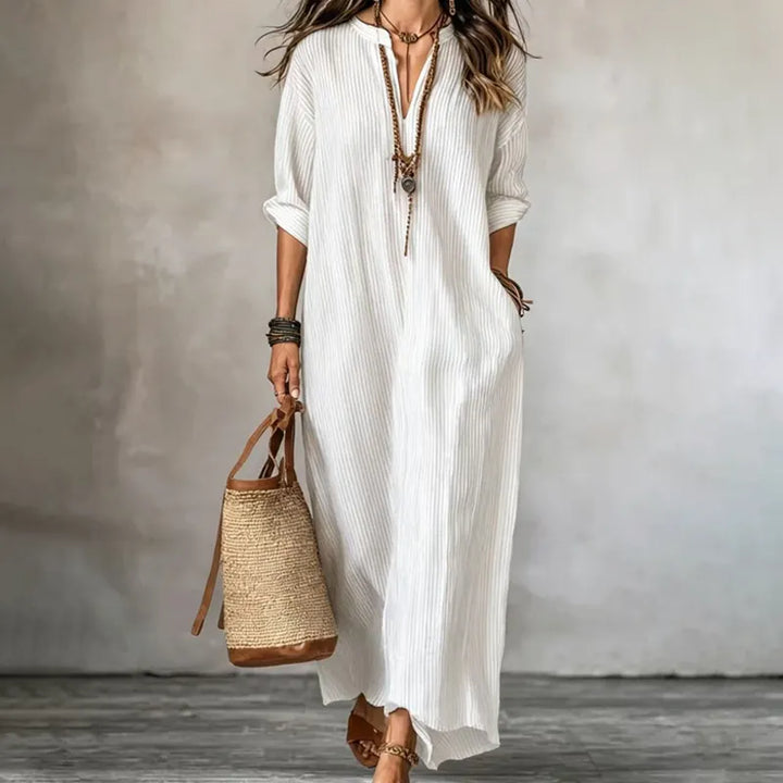 Elegante abito maxi donna a righe con scollo a V e pratiche tasche. Versatile per outfit casual o chic.