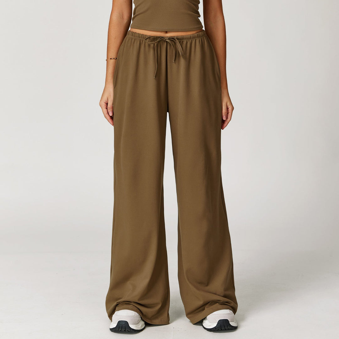 Comodi pantaloni donna larghi, vita alta, per massimo comfort. Design casual-sportivo con trendy dettaglio pendente.