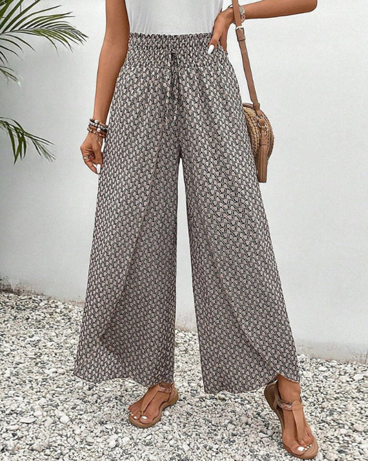 Comodi pantaloni larghi da donna, stampa geometrica vibrante, stile casual-elegante per tutte le stagioni.