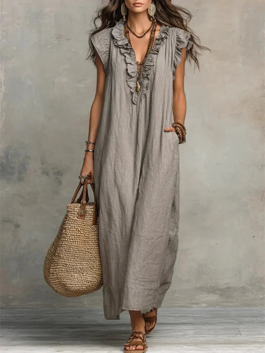 Maxi abito boho donna con scollo a V, balze fluide e pratiche tasche. Perfetto per l'estate casual.