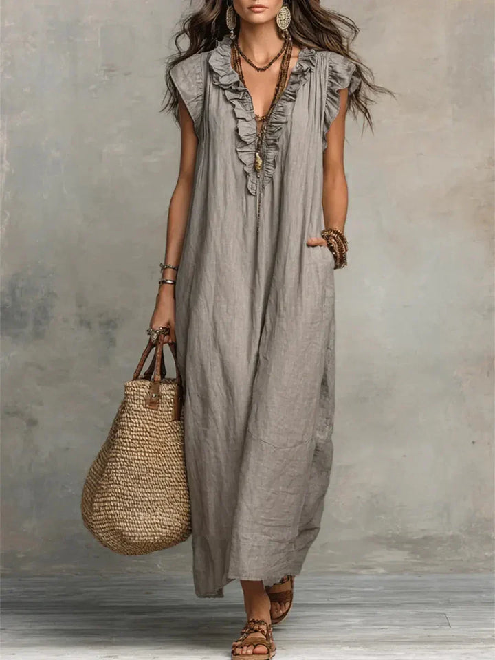 Maxi abito boho donna con scollo a V, balze fluide e pratiche tasche. Perfetto per l'estate casual.