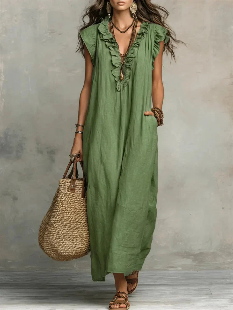Elegante vestito lungo boho estivo con scollo a V e balze, ideale per look casual chic e confortevoli.