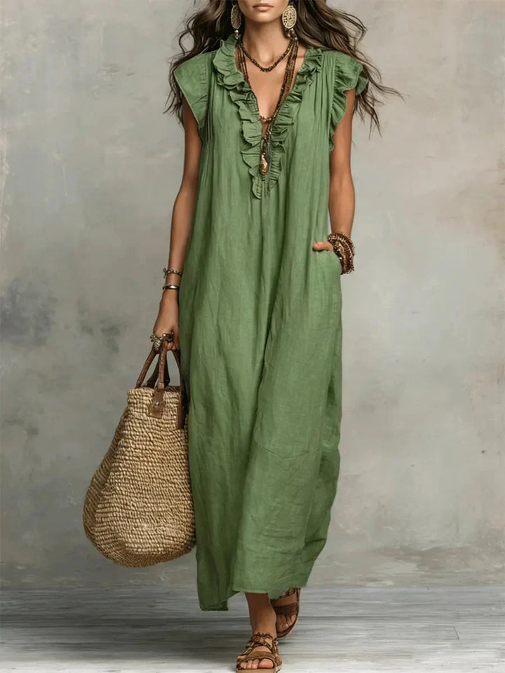 Elegante vestito lungo boho estivo con scollo a V e balze, ideale per look casual chic e confortevoli.