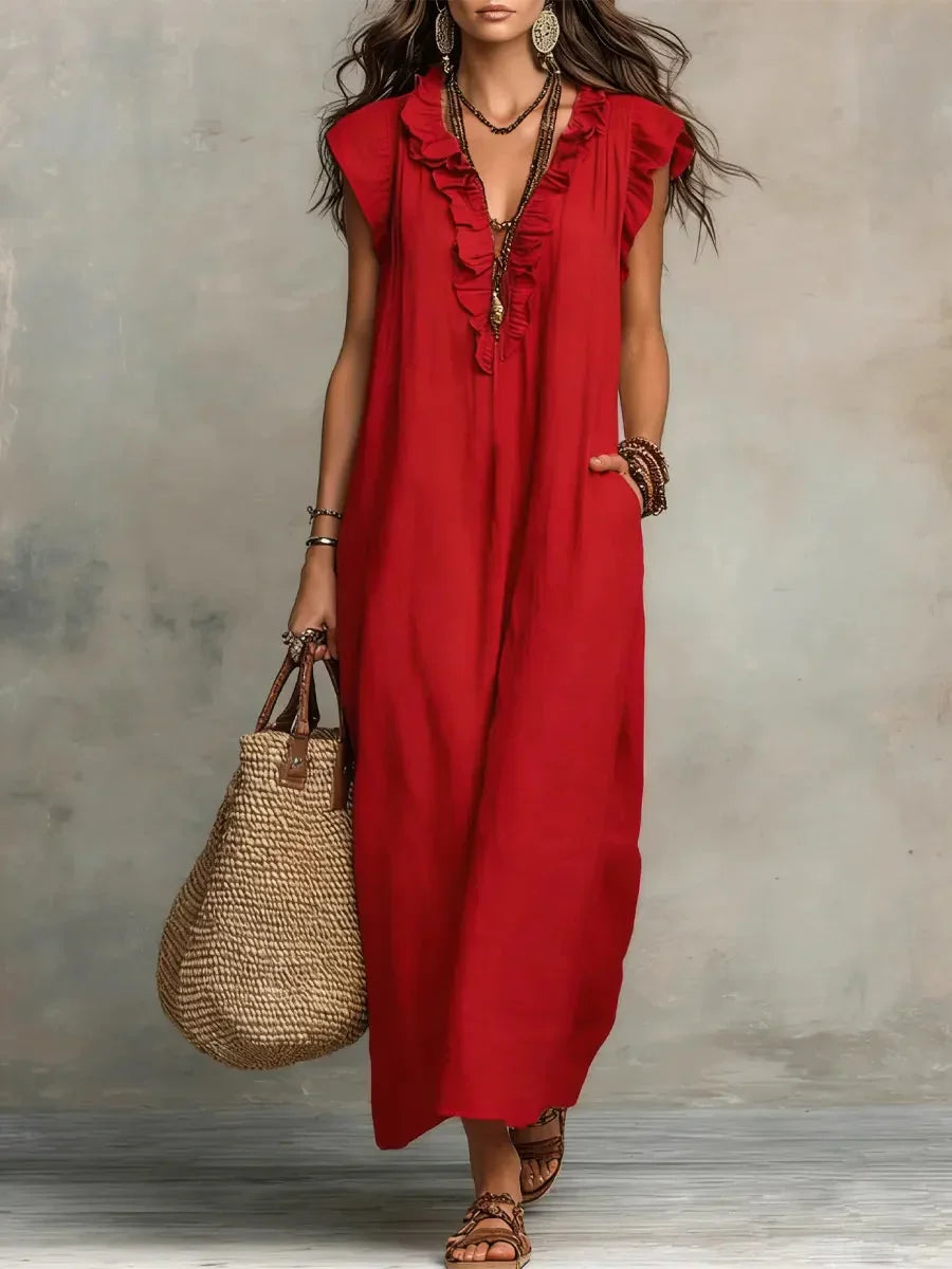 Maxi abito donna bohémien con scollo a V profondo, maniche ampie e dettagli balze, dotato di comode tasche.