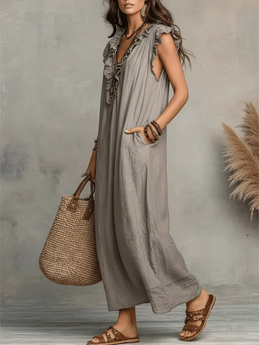 Abito estivo donna maxi con scollo a V, balze decorative e tasche utili, per un comfort bohémien.