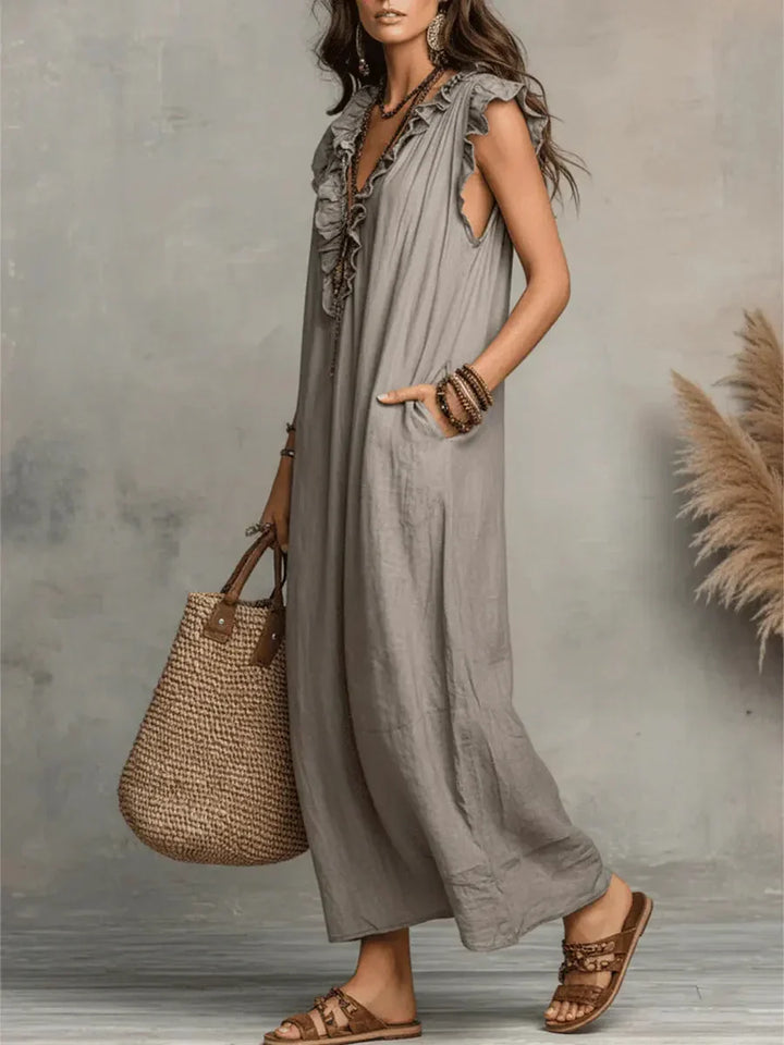Abito estivo donna maxi con scollo a V, balze decorative e tasche utili, per un comfort bohémien.