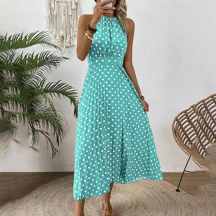 Elegante abito maxi estivo da donna con fantasia a pois e design con collo halter.