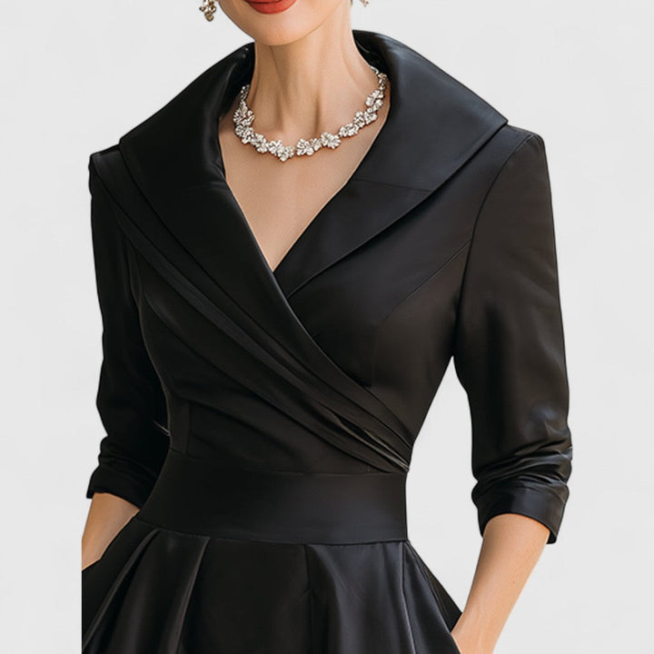 Abito midi nero donna, scollo a V, tasche e maniche tre quarti, un capo must-have per eleganza.