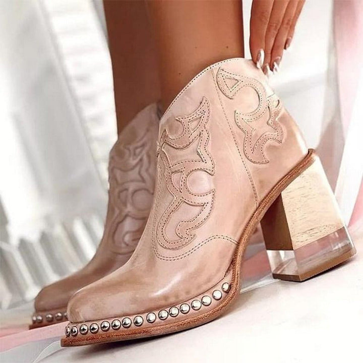 Stivaletti cowboy da donna in pelle sintetica nera con zip, tacco largo e punta affusolata. Perfetti per un look western.