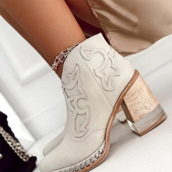 Moda calzature: stivaletti cowboy donna in pelle sintetica con tacco largo, zip e design western moderno.