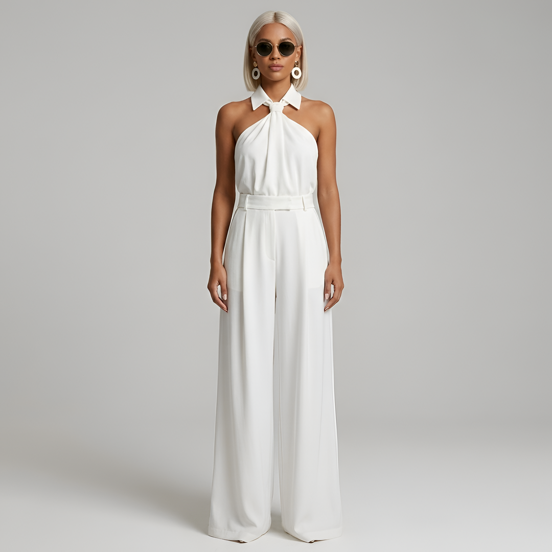 Tuta donna di tendenza con collo all'americana e gamba ampia, per un look fluido ed elegante da cerimonia o sera.