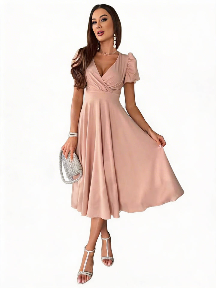 Abito midi elegante da donna con maniche a sbuffo e gonna svasata, perfetto per cerimonia o party.