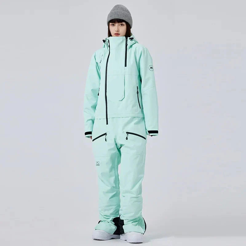 Tuta da sci monopezzo donna, impermeabile e calda, ideale per sport invernali e protezione dal freddo.