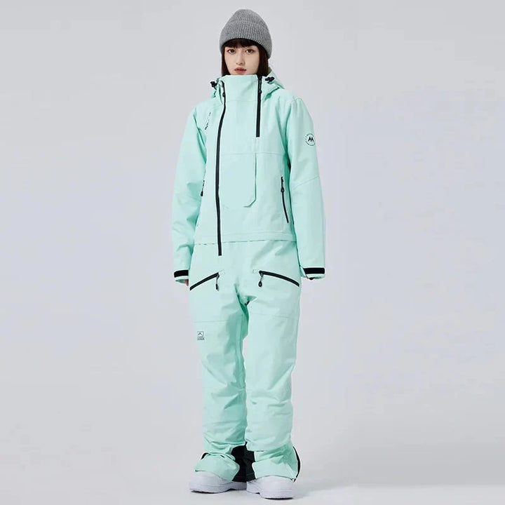 Tuta da sci monopezzo donna, impermeabile e calda, ideale per sport invernali e protezione dal freddo.