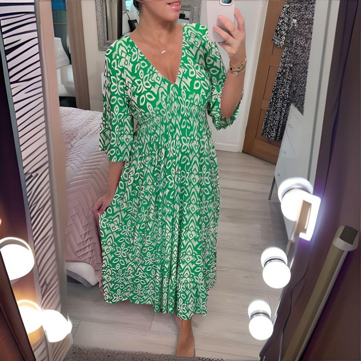 Chic abito lungo boho da donna con vivace stampa grafica e scollo a V. Look estivo e confortevole.